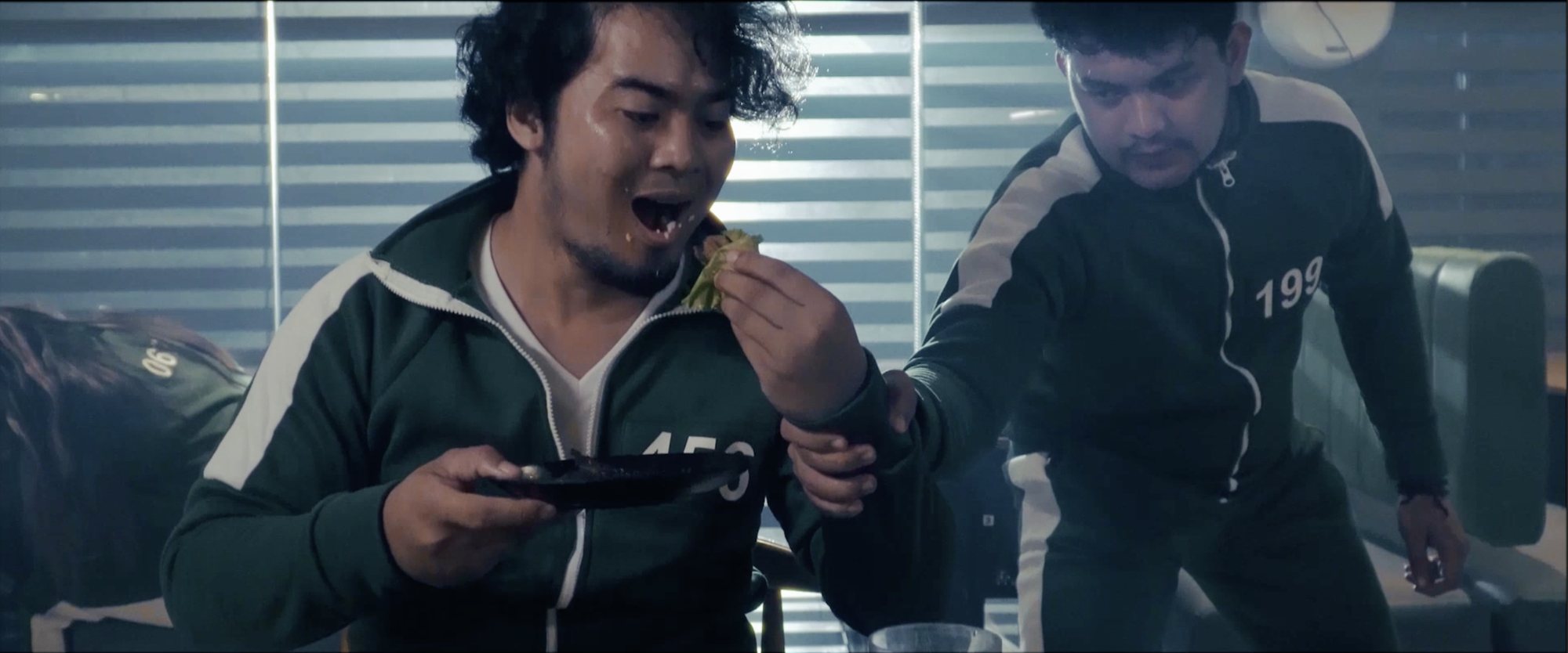 Two diners laughing over grilled food